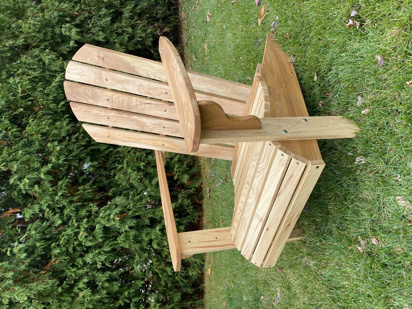 Handcrafted cedar Adirondack chair sitting in grass