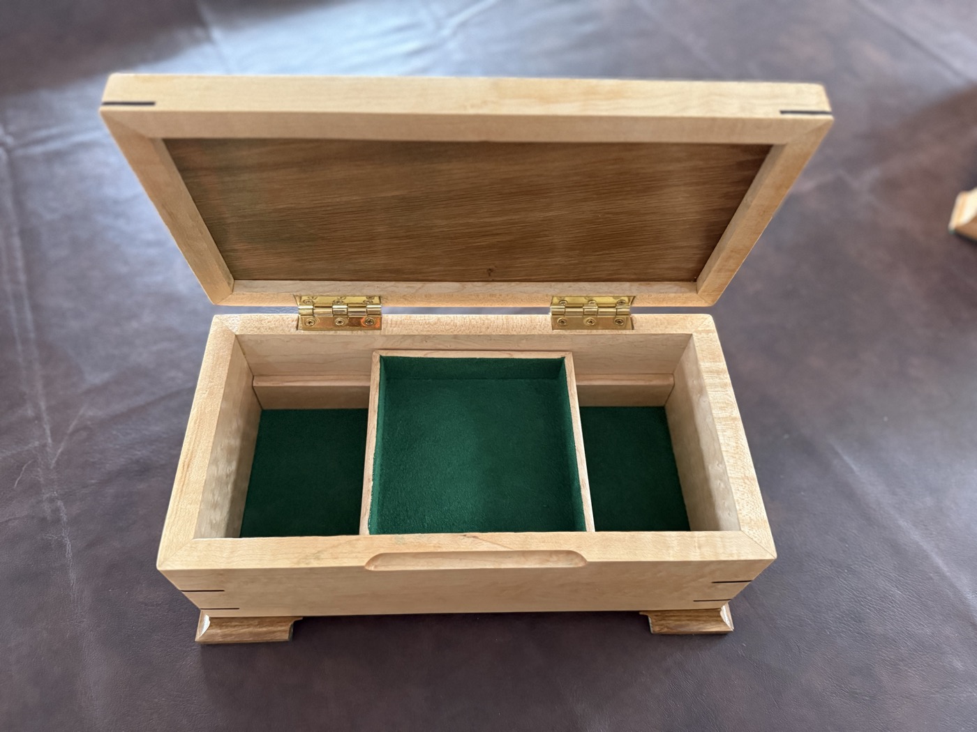 Handcrafted maple keepsake box open showing green felt-lined interior