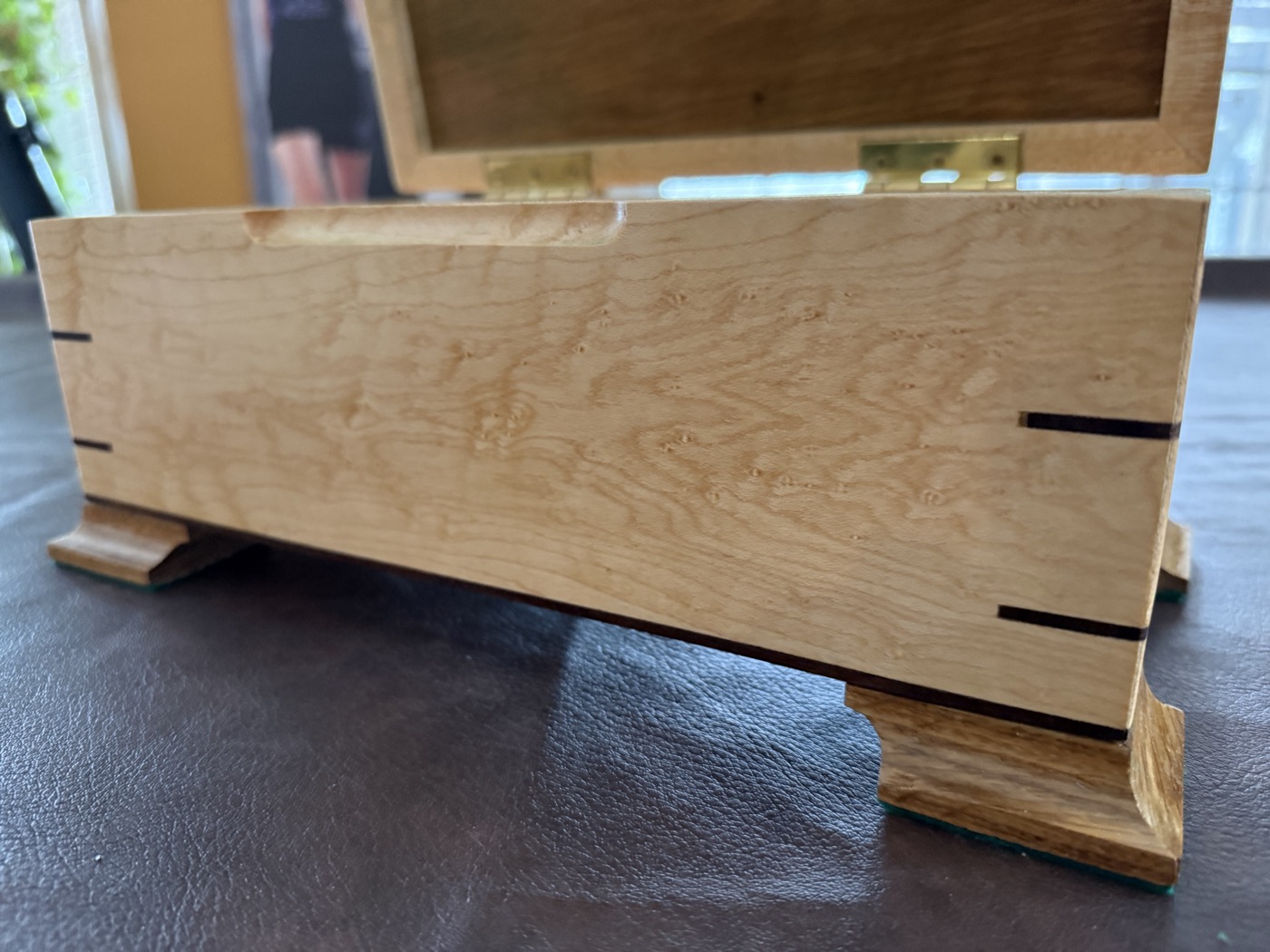 Burl maple keepsake box side view showing dovetail joinery and grain